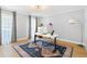 Bright office with a modern desk, stylish rug, ample natural light, and neutral gray walls for a serene work environment at 1661 Duxbury Nw Ln, Kennesaw, GA 30152