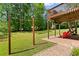 Outdoor patio with outdoor seating and view of a lush green backyard and upper deck at 1661 Duxbury Nw Ln, Kennesaw, GA 30152