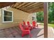 Charming outdoor patio with red Adirondack chairs creates a cozy gathering spot with shaded comfort at 1661 Duxbury Nw Ln, Kennesaw, GA 30152