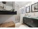 Modern bathroom featuring double sinks, modern mirrors, a glass shower, and storage space at 2572 Beverly Hills Drive Dr, Chamblee, GA 30341