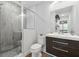 Modern bathroom boasts a glass shower, dark vanity, and sink, offering a sleek design at 2572 Beverly Hills Drive Dr, Chamblee, GA 30341