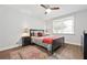 Cozy bedroom features an area rug, bed with accent pillows, dresser, and window at 2572 Beverly Hills Drive Dr, Chamblee, GA 30341