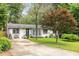 Inviting single-story home with a well-manicured front lawn, driveway, and charming curb appeal at 2572 Beverly Hills Drive Dr, Chamblee, GA 30341