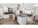 Open-concept kitchen boasts a large island with granite countertops, stainless appliances, and white cabinets at 2572 Beverly Hills Drive Dr, Chamblee, GA 30341