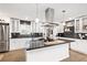 Bright kitchen featuring stainless appliances, white cabinets, dark backsplash, granite countertops, and a large island at 2572 Beverly Hills Drive Dr, Chamblee, GA 30341