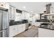 Bright kitchen with stainless appliances, white cabinets, granite countertops, and dark backsplash at 2572 Beverly Hills Drive Dr, Chamblee, GA 30341