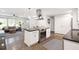 Open-concept kitchen featuring a large island, stainless appliances, white cabinets, and hardwood floors at 2572 Beverly Hills Drive Dr, Chamblee, GA 30341