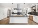 Bright kitchen with granite counters, a stainless hood, stainless appliances, and white cabinets at 2572 Beverly Hills Drive Dr, Chamblee, GA 30341