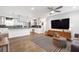 Open-concept living space with a modern kitchen, comfortable seating area, and hardwood floors at 2572 Beverly Hills Drive Dr, Chamblee, GA 30341