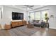 Cozy living room featuring stylish furniture, a ceiling fan, and large windows providing natural light at 2572 Beverly Hills Drive Dr, Chamblee, GA 30341