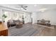 Bright and airy living room with hardwood floors, ceiling fan, comfortable seating, and ample natural light at 2572 Beverly Hills Drive Dr, Chamblee, GA 30341