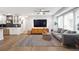 Open-concept living space with a modern kitchen, comfortable seating area, and hardwood floors at 2572 Beverly Hills Drive Dr, Chamblee, GA 30341