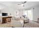Bright living room offering comfortable seating, a nearby office space, and access to the home's kitchen at 2572 Beverly Hills Drive Dr, Chamblee, GA 30341
