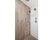 Close up view of shower featuring adjustable showerhead and stylish wood look ceramic tiles at 2572 Beverly Hills Drive Dr, Chamblee, GA 30341