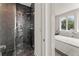 Bathroom with a large black tiled shower and a view into the bedroom with natural light at 380 2Nd St, Fayetteville, GA 30214