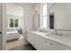 Bright bathroom with double vanity, modern mirrors, and a view into the adjacent bedroom at 380 2Nd St, Fayetteville, GA 30214