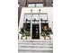 Elegant shop entrance with potted plants and a white brick facade, offering a welcoming storefront at 380 2Nd St, Fayetteville, GA 30214