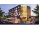 Modern mixed-use building with prominent signage, pedestrian activity, and street-level retail at 380 2Nd St, Fayetteville, GA 30214