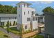 A modern home with a unique tower design, complemented by fresh landscaping and a welcoming walkway at 380 2Nd St, Fayetteville, GA 30214