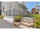 Modern home with stone steps, sleek railings, and professionally landscaped entrance at 380 2Nd St, Fayetteville, GA 30214