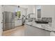 Bright kitchen features stainless steel appliances, gray marble countertops, and white cabinetry at 380 2Nd St, Fayetteville, GA 30214