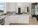 Bright kitchen with granite countertops, white cabinetry, stainless steel appliances, and hardwood floors at 380 2Nd St, Fayetteville, GA 30214