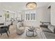 Open-concept living space features hardwood floors, a modern chandelier, and ample natural light at 380 2Nd St, Fayetteville, GA 30214