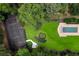Expansive property featuring a basketball court, putting green, and a sparkling pool, all surrounded by lush greenery at 4560 Harris Trl, Atlanta, GA 30327