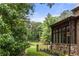 Lush private backyard with mature trees, a stone patio, manicured lawn, and a garden at 4560 Harris Trl, Atlanta, GA 30327