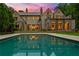 Luxury home showcasing a refreshing backyard pool that reflects the home's elegant architecture at 4560 Harris Trl, Atlanta, GA 30327