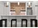 Modern bar area featuring seating, white cabinets, tile backsplash, and stainless steel refrigerator at 4560 Harris Trl, Atlanta, GA 30327