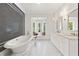 Bright bathroom featuring a freestanding tub, black and white tiling, and a window seat at 4560 Harris Trl, Atlanta, GA 30327