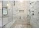 Shower with marble tiling, a glass enclosure, and modern fixtures at 4560 Harris Trl, Atlanta, GA 30327
