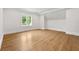 Empty bedroom with hardwood floors, white walls, and a bright window at 4560 Harris Trl, Atlanta, GA 30327