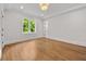 Empty bedroom featuring hardwood floors, white walls, and a bright window at 4560 Harris Trl, Atlanta, GA 30327