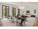 Spacious main bedroom suite with a seating area, large windows, and a stylish chandelier at 4560 Harris Trl, Atlanta, GA 30327
