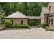 Charming brick home with a porte-cochere, manicured landscaping, and a circular driveway at 4560 Harris Trl, Atlanta, GA 30327