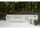 Modern outdoor fire pit area with built-in seating and tranquil landscaping at 4560 Harris Trl, Atlanta, GA 30327