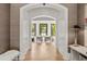 Stunning foyer with hardwood floors, white trim, and an open archway leading to the living room at 4560 Harris Trl, Atlanta, GA 30327