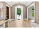 Elegant foyer with herringbone wood floors, arched doorways, and stylish lighting fixtures at 4560 Harris Trl, Atlanta, GA 30327