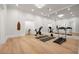 Home gym featuring a punching bag, treadmill, exercise bike, large mirror, and hardwood floors at 4560 Harris Trl, Atlanta, GA 30327
