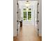 Hallway with a window bringing in natural light and open doors that show the beautiful home design at 4560 Harris Trl, Atlanta, GA 30327