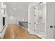 Hallway with hardwood flooring, leading to butler's pantry with white cabinetry and marble countertop at 4560 Harris Trl, Atlanta, GA 30327