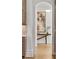 Hallway leading to kitchen featuring wood flooring and arched doorway at 4560 Harris Trl, Atlanta, GA 30327