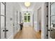 Bright hallway with shiplap walls, hardwood floors, and a view of the lush outdoors through the window at 4560 Harris Trl, Atlanta, GA 30327