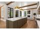 Modern kitchen with a large island, stainless appliances, and open living space at 4560 Harris Trl, Atlanta, GA 30327