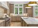 Gourmet kitchen with a marble island, stainless steel appliances, and ample natural light at 4560 Harris Trl, Atlanta, GA 30327