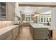 Open-concept kitchen showcasing a large island, custom cabinets, and stainless steel appliances at 4560 Harris Trl, Atlanta, GA 30327