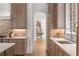 Kitchen area with gray cabinets, stone countertops, stainless steel sink and faucet, and access to the hall at 4560 Harris Trl, Atlanta, GA 30327