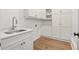 Well-organized laundry room with white cabinets and quartz countertop at 4560 Harris Trl, Atlanta, GA 30327
